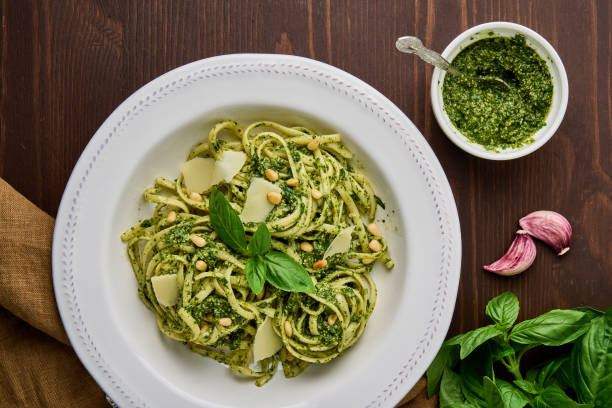Italian spaghetti pesto with pine nuts, garlic, basil leaves, parmesan cheese and olive oil stock photo