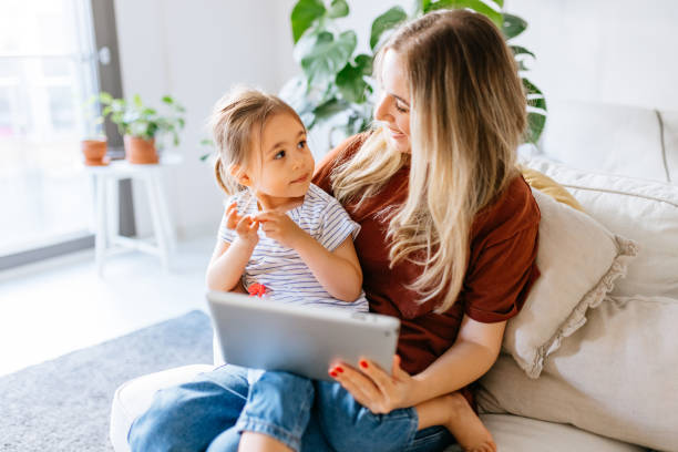 istock Mother and daughter using a digital tablet together 1344564046
