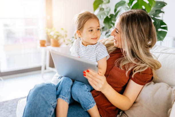istock Mother and daughter using a digital tablet together 1344564082