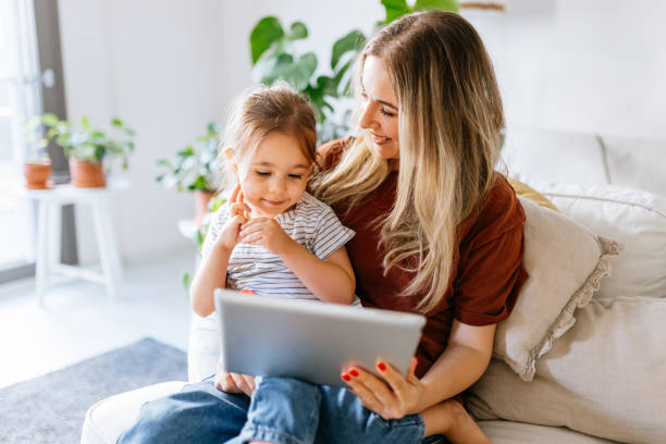 istock Mother and daughter using a digital tablet together 1344564117