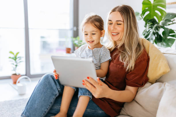 istock Mother and daughter using a digital tablet together 1344564146