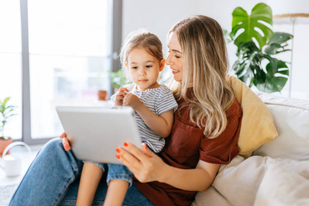 istock Mother and daughter using a digital tablet together 1344564170