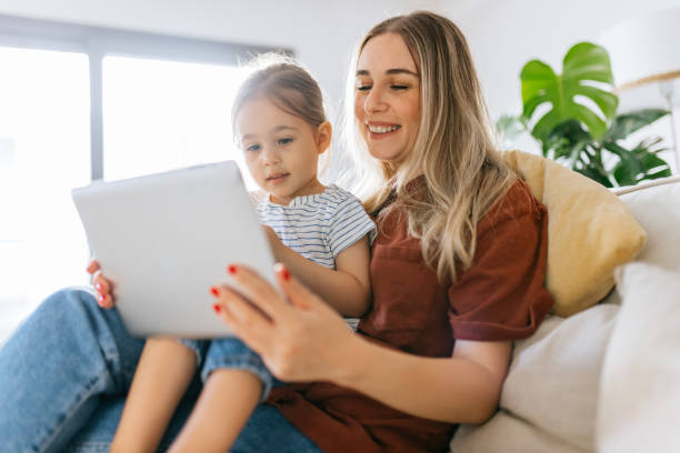 istock Mother and daughter using a digital tablet together 1344564220