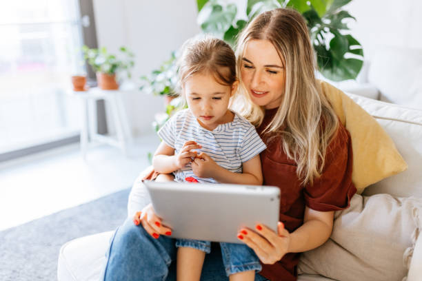 istock Mother and daughter using a digital tablet together 1344564249