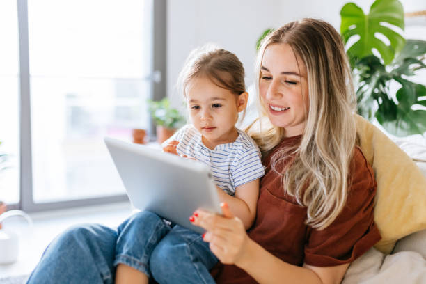 istock Mother and daughter using a digital tablet together 1344564296