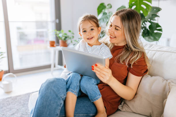 istock Mother and daughter using a digital tablet together 1344564314