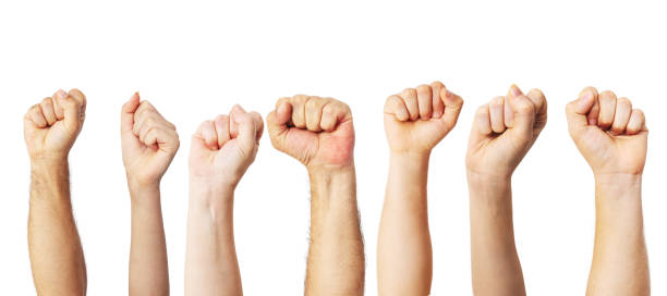 Group of people raised fists up as a victory, proud, success or strength symbol stock photo