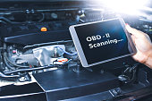 Technician diagnostics of code failure with OBD2 scanner technology on tablet