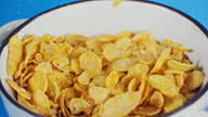 istock Pouring Cornflakes from Box into Bowl for Breakfast Super Slow Motion 1344569726