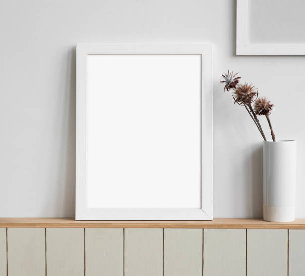 istock Artworks mock-up in interior design. Blank white picture frame on a grey wall 1344569872