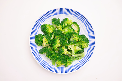 Broccoli on a plate on white background