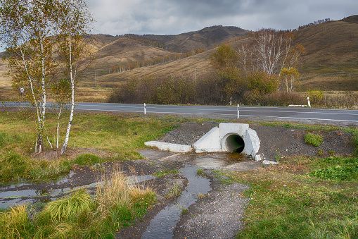 Culvert located under the road. Russia