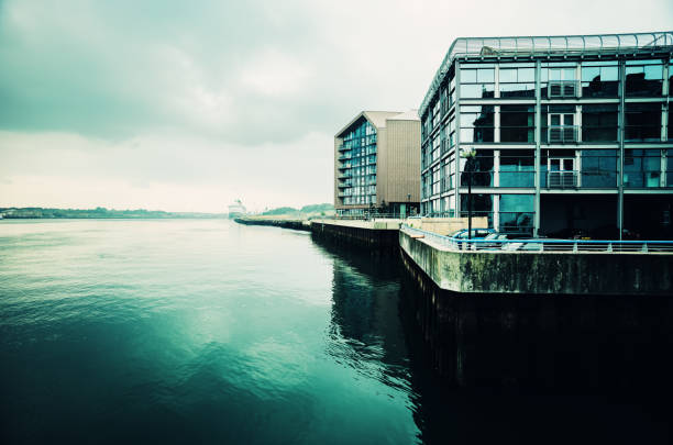 North Shields, England - September, 06 2021:  View eastwards along the Tyne River from the North Shields ferry terminal, England, looking past the Brewery Bond apartments building on an early autumn morning.