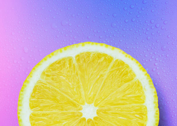 juicy ripe lemon cut slice on bright background with drops