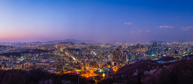 Aerial panorama over the illuminated sunset cityscape of central Seoul, South Korea’s vibrant capital city.