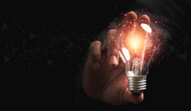 istock Businessman holding lightbulb glowing with connection line for creative thinking ideas and innovation concept. 1344574572