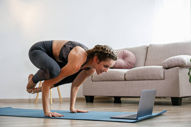 istock Yogini exercising at home 1344574757
