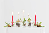 home christmas decor with burning candles in whte interior