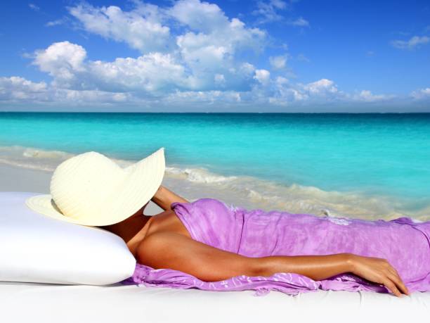istock Caribbean tourist resting beach hat woman 1344576019