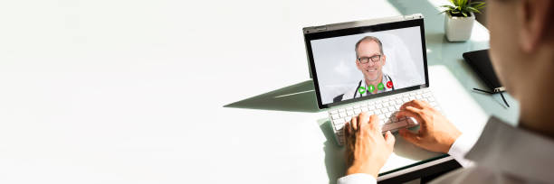 istock Businessman videoconferencing with doctor on laptop 1344576856