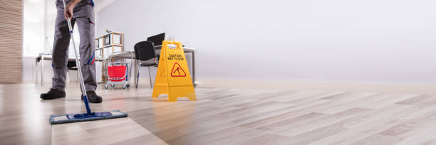 istock Male Janitor Cleaning Floor In Office 1344576911