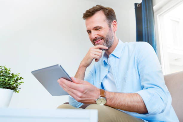 Handsome businessman working from home stock photo
