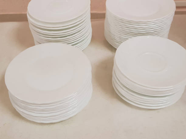 istock White clean empty plates in a stack on the table, service in the hotel cafe 1344579872