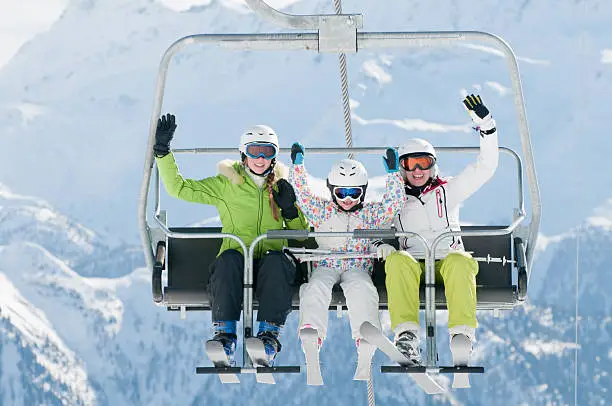 Happy skiers on ski lift 