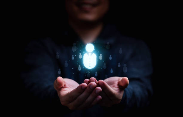 istock Businessman holding virtual human icon for focus customer group or human recruitment and development concept. 1344582462