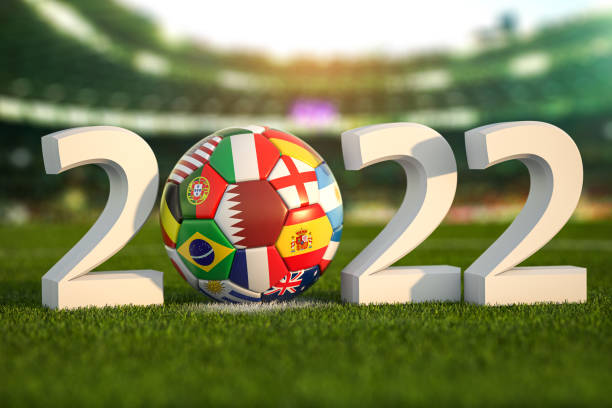 Football world championship 2022 in Qatar. Soccer ball with flags of world countries on the grass field of football stadium. . stock photo