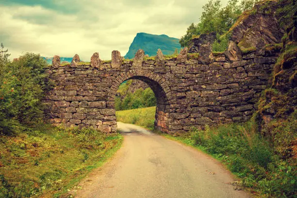 Stone arch over the road. Beautiful nature