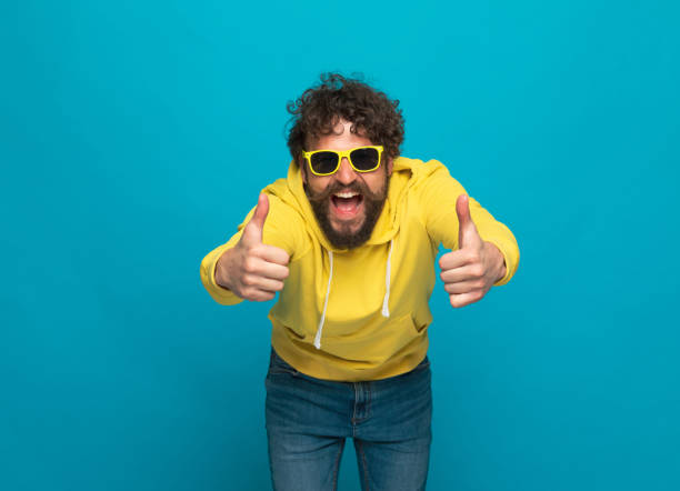 istock funny young man with moustache making thumbs up gesture 1344585098