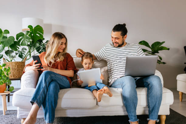 Family spend free time at home surfing internet