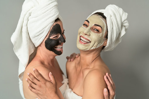 Happy middle age women with facial mask having skin care spa day - People selfcare lifestyle concept