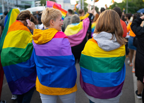 istock Lesbian women couple wearing flags during pride event 1344587400