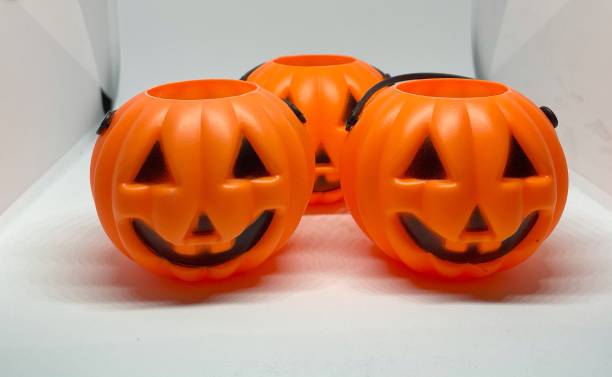 istock Many Halloween Pumpkins in a row isolated on white background 1344587721