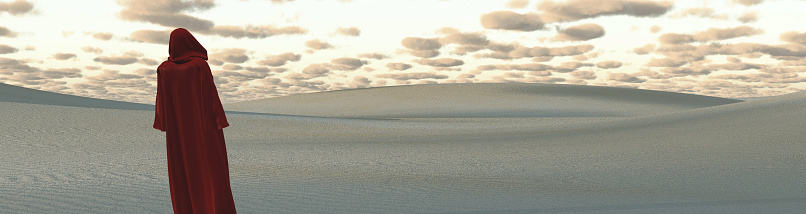 Mysterious hooded figure in desert landscape. 3D rendering