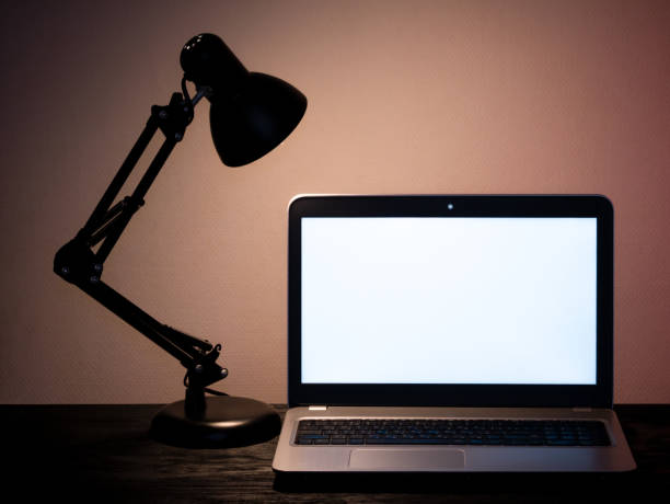 istock Laptop and table lamp at workplace. Distance work concept in quarantine. Modern freelance. 1344592373