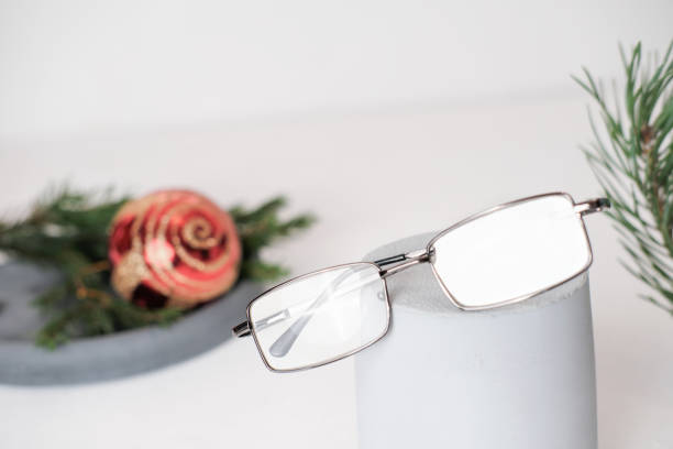 istock eyeglasses on a grey geometric podium. christmas decor. eye sight, vision concept. optic store winter sale 1344594430