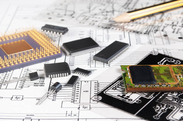 istock Electronic board, pen, processor and radio components on background of  schematic circuit diagram and a photomask for manufacture of printed circuit boards. Concept for development and design of electronic devices. 1344595373