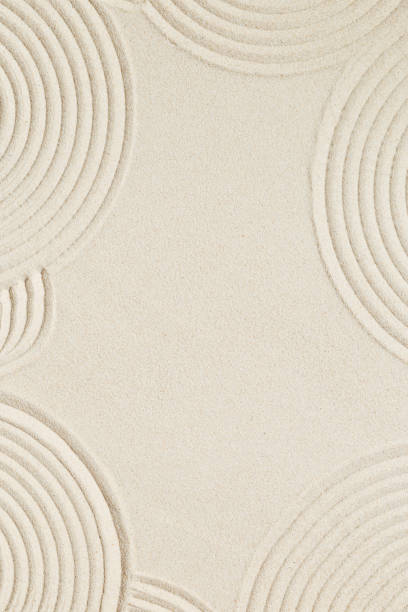istock Lines drawing on sand, beautiful sandy texture. Spa background, concept for meditation and relaxation 1344598977
