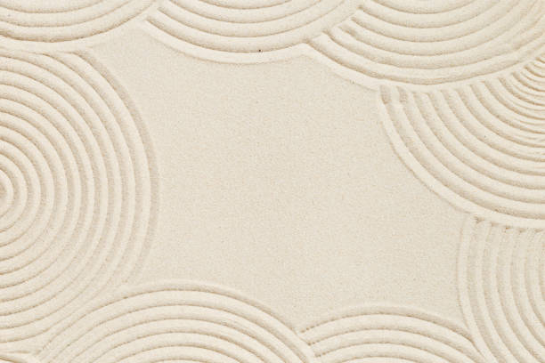 istock Lines drawing on sand, beautiful sandy texture. Spa background, concept for meditation and relaxation 1344598978