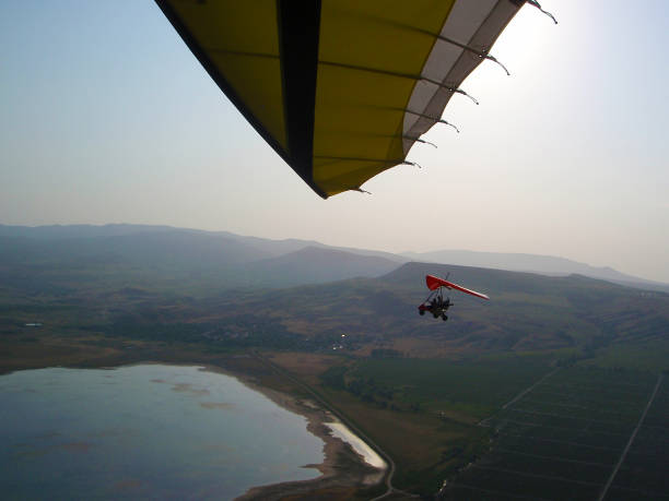 istock The instructor pilot and passenger sit in a hang glider 1344601757