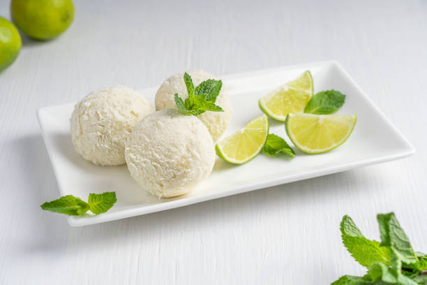 kugeln limetten- und minzeeis auf teller auf weißem holztisch serviert - lemon ice cream stock-fotos und bilder