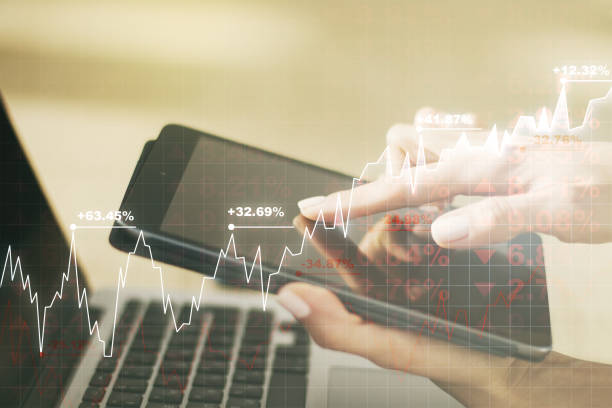 istock Abstract creative financial graph with finger clicks on a digital tablet on background, financial and trading concept. Multiexposure 1344606081