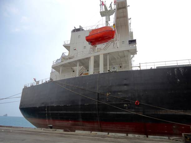 istock The big cargo ship is leaned on a harbor jetty 1344608677