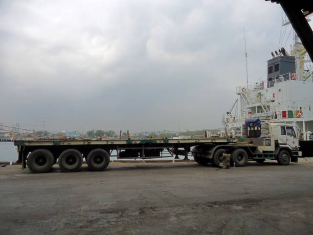 truck positioned near a large vessel