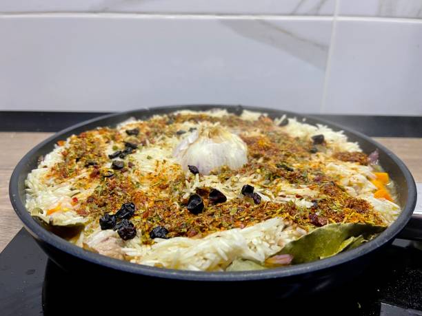 istock cooking pilaf with meat in a pan 1344608700