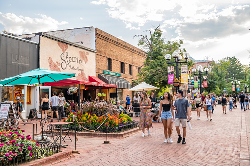Boulder, CO - August 28, 2021: Young people explore the famous Pearl Street Mall, downtown, on a beautiful evening.