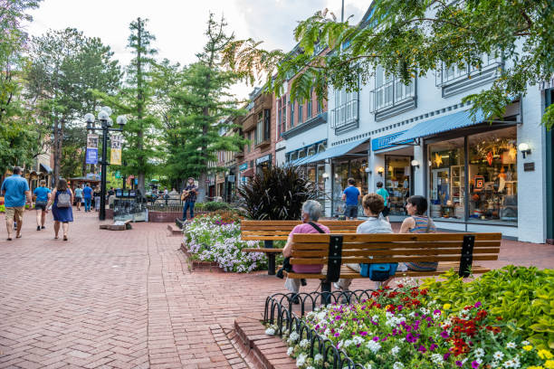 In Boulder, Colorado, Women friends sit together and enjoy the evening on the Pearl Street Mall Boulder, CO - August 28, 2021: Women friends sit together and enjoy the evening on the famous Pearl Street Mall, downtown, on a beautiful evening. small town stock pictures, royalty-free photos & images
